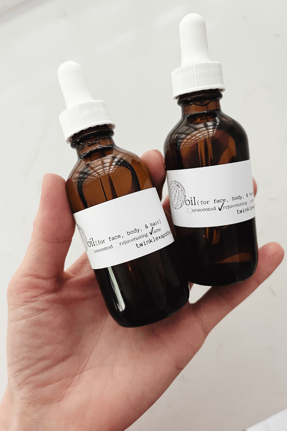 2 oz bottles of twinkle apothecary oil: multitasking moisturizer for face, body, and hair 